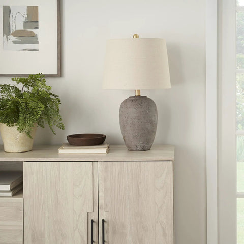 Rustic Farmhouse Ceramic Table Lamp With Beige Linen Shade, Gray Brown Earth Tones on light wood cabinet