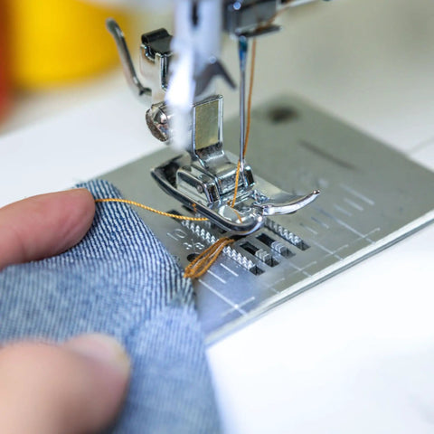 Close-up of sewing machine using Heavy Duty Jeans Sewing Thread 1500 Yards 20s 2 Polyester Spool for denim stitching