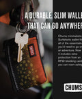 Surfshorts Wallet With RFID Blocking Clear ID Window Zippered Pocket And Key Ring Water Resistant Slim Card Holder For Everyday Carry Ultra Lightweight And Slick Compact In Black Blue hanging from a car key.