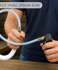 Knock The Gunk Right Out Of Your AC System With This Tough CO2 Drain Gun holding a flexible hose for HVAC cleanup.