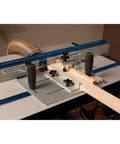 Router Table Coping Sled Kit with Sacrificial Backing Board in use on a router table for precise coping cuts in wood.