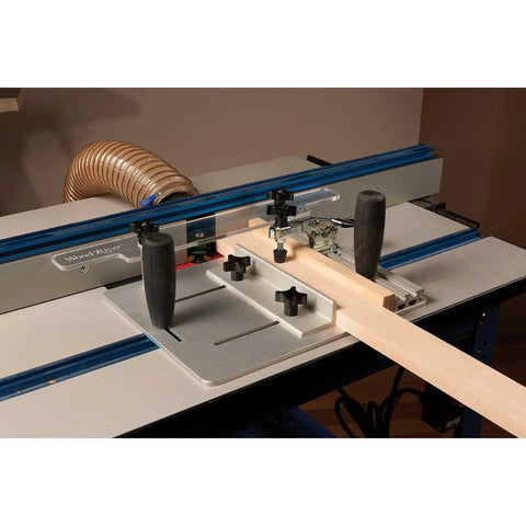 Router Table Coping Sled Kit with Sacrificial Backing Board in use on a router table for precise coping cuts in wood.