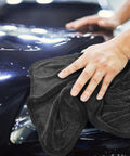 Person using Super Absorbent Microfiber Car Drying Towel Thickened Lint Free Auto Wash Cloth on a shiny car surface.