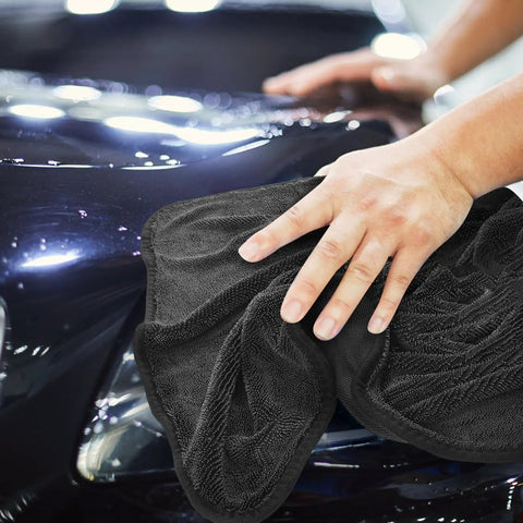 Person using Super Absorbent Microfiber Car Drying Towel Thickened Lint Free Auto Wash Cloth on a shiny car surface.