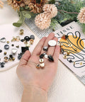 Level Up Your Look With These Top Shelf 30 Piece Heart Shaped Metal Stud Rivets 10Mm Screw Back Embellishments Ideal For Leather Gear Bags And Clothing DIY Projects Silver, assorted rivets in hand.