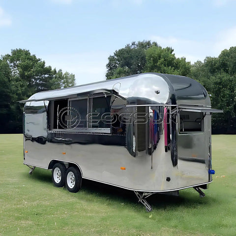 Lightweight Mobile Food Trailer With Full Plumbing And Electrical Wiring Solid Rig For Your Downtown Block Party Or Street Food Hustle Ready To Roll Smooth Today, shiny silver trailer on grass.