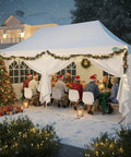 10x20 Pop Up Canopy With 6 Sidewalls For Parties And Outdoor Events, Waterproof UV50 Instant Shelter Gazebo, 200 Sq Ft Coverage, Accommodates 15 To 20 People, Peak Roof With Enhanced Drainage And Included Sandbags set up for a festive outdoor gathering with snow and holiday decorations.