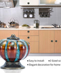 Durable Blue Pumpkin Cabinet Knobs 12 Pack Glazed Ceramic Vintage Door Pulls displayed in a kitchen setting with rustic cabinets.