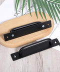 2 Pack Sliding Door Pull Handles Black Matte Aluminum Hole Center Gate Handles for wooden doors displayed on a wooden surface.