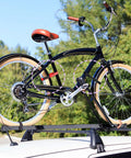 Bicycle secured on roof rack using 12 Pack Adjustable Bike Rack Straps 23.6 Inch Cinch Straps For Wheel Stabilization Multi Color Black Purple Red