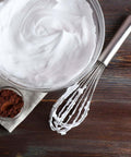 3 Pack Stainless Steel Balloon Whisks Set For Cooking, Blending, Beating And Stirring next to whipped cream in a bowl