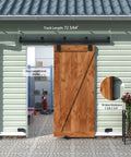 Outdoor wall with 6Ft Black Exterior Sliding Barn Door Hardware Track Kit, wooden barn door installed, weatherproof rail system.