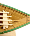 Close-up of model boat interior from Shipwright Series 3 Kits Trio With Tools For Adults Learn As You Build Fully Planked Historic Wooden Ship Models From A 1800s Fishermans Dory To A Norwegian Pram And Lobster Smack, showcasing wooden planks and oars.