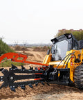 Workhorse Skid Steer Trencher Attachment with Beefy Steel Frame and Tungsten Carbide Teeth in action on construction site