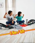 Two children playing with Formula 1 Grand Prix Circuit Track Set With 3 Die Cast 1 To 64 Scale Cars Two Racing Modes And A Motorized Booster