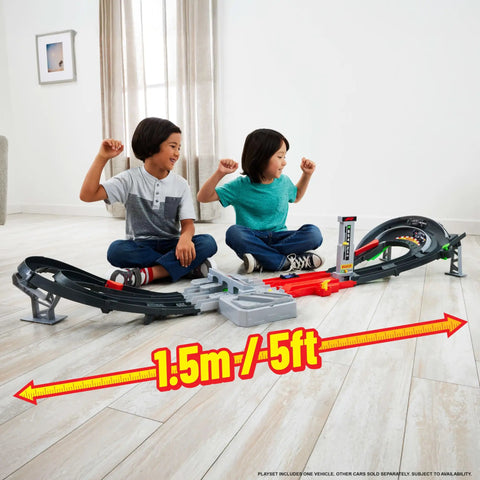 Two children playing with Formula 1 Grand Prix Circuit Track Set With 3 Die Cast 1 To 64 Scale Cars Two Racing Modes And A Motorized Booster