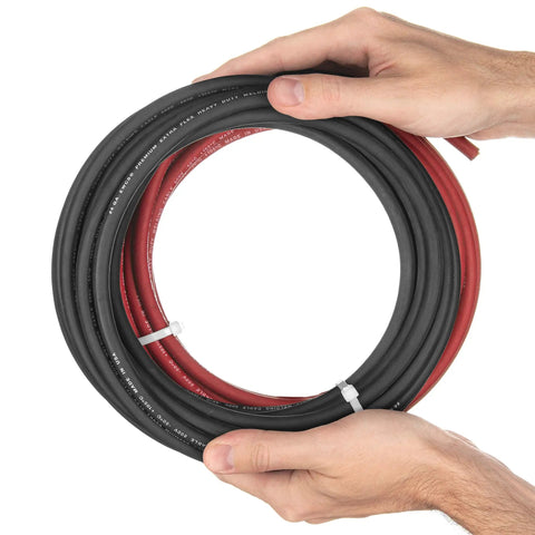 Hands holding 4 Gauge Premium Copper Welding Cable Set, Extra Flexible Pro Grade 600 Volt, 15 Feet Black and 15 Feet Red