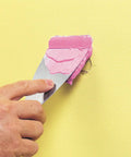 Applying Spackling For Interior And Exterior Use 1/2 Pint White No Mess Easy To Use Squeeze Tube With Dry Time Indicator on wall