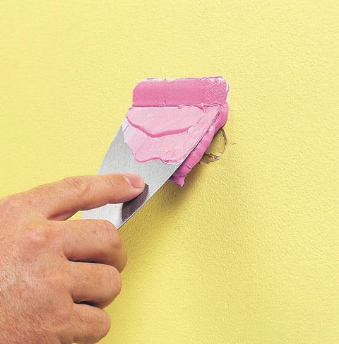 Applying Spackling For Interior And Exterior Use 1/2 Pint White No Mess Easy To Use Squeeze Tube With Dry Time Indicator on wall
