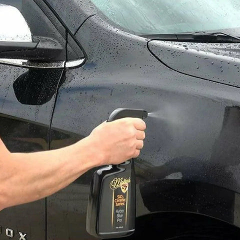 Hand applying Hydro Blue PRO SiO2 Ceramic Coating Spray On Rinse Off Easy High Gloss Finish With Hydrophobic Protection to car