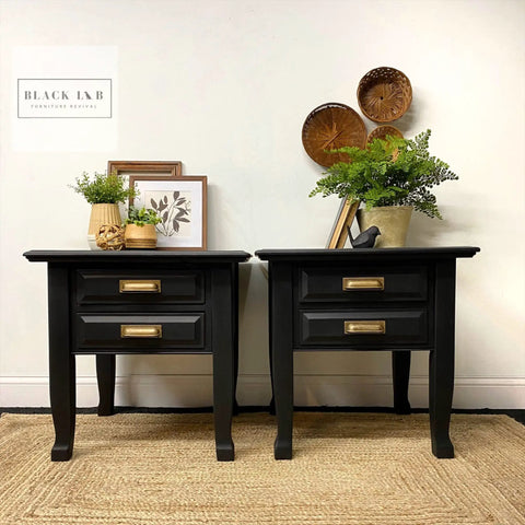 Two black end tables painted with Chalk Mineral Furniture Paint Matte Black Caviar 16oz, styled with decor items.