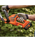 Man holding 40V Max Hedge Trimmer With 22 Inch Dual Action Blade Low Vibration for Smooth Cuts Up To Three Quarters Inch Thick