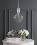 Chrome Mid Century Modern 10.5 Inch One Light LED Pendant Light Fixture with adjustable stem and clear glass shade in a dining room.