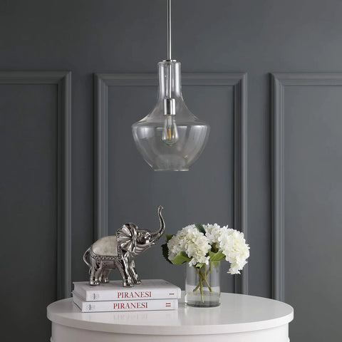 Chrome Mid Century Modern 10.5 Inch One Light LED Pendant Light Fixture with adjustable stem and clear glass shade in a dining room.