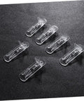 Beefy Plastic Locking Shelf Support Pegs With Smooth Grip Tops For Cupboards Medicine Cabinets And Glass Drink Stands A Top Grade Thirty Piece Cabinet Hardware Fix That Swaps Out Quick And Stays Put - clear plastic pegs on a black surface.