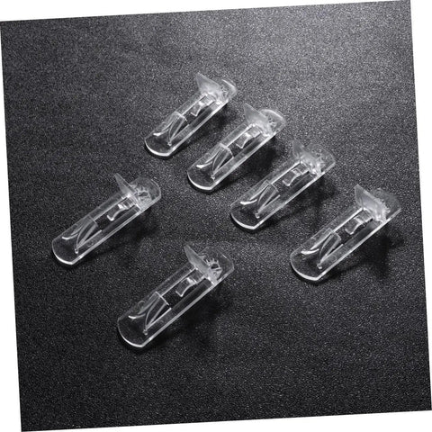 Beefy Plastic Locking Shelf Support Pegs With Smooth Grip Tops For Cupboards Medicine Cabinets And Glass Drink Stands A Top Grade Thirty Piece Cabinet Hardware Fix That Swaps Out Quick And Stays Put - clear plastic pegs on a black surface.