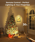 Rechargeable Indoor LED Spotlight Kit with Smart Auto Timer illuminating a Christmas tree and artwork using remote control.