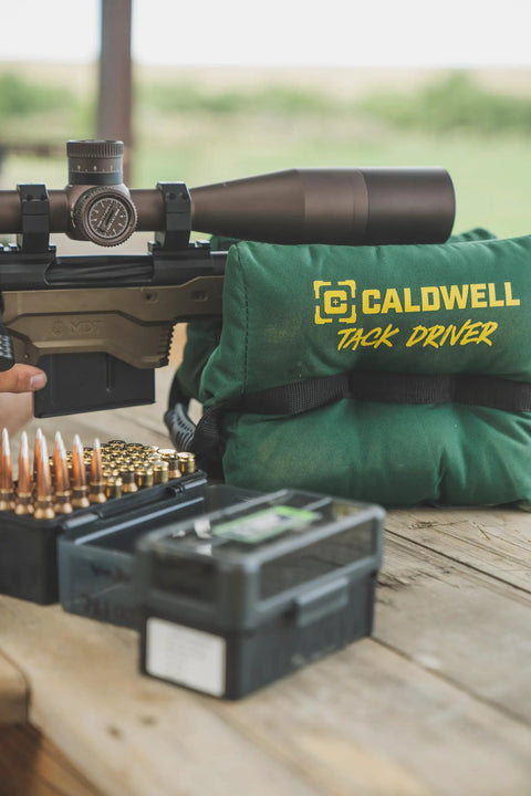 TackDriver Gun Bag With One Piece Construction And Non Marring Surface For Outdoor Range And Hunting on a wooden bench.