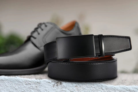 Mens Leather Ratchet Belt With Easy Release Buckle Adjustable Fit Up To One Fifth Inch Increments 35mm Wide next to black shoes