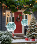 8 Pack Outdoor Solar Hanging Lights Waterproof Lanterns For Garden Decor Cold White Cracked Glass glowing in snowy garden scene