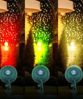 OSKOS Outdoor LED Christmas Waterproof Floodlight, 4.8W LED Waterproof Color Stake Light shining red, green, and white outdoors.