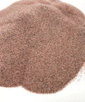 Garnet abrasive media pile, fine grade #100/120 grit, reddish-brown granules