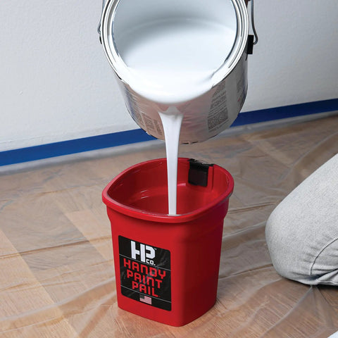 Grab And Go 32 Ounce Paint Pail With Magnetic Brush Holder And Built In Scraper, Hands Free Strap And Belt Clip, Solvent Resistant, Holds A Quart Of Paint Or Stain For Trim Cut-Ins And Small Painting Projects Red with white paint being poured into it
