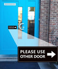 2 Pack Please Use Other Door Sign With Left Right Arrow Self Adhesive Weatherproof Vinyl Entrance Sticker on blue door.
