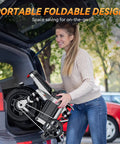 Woman lifting Beast Of A Foldable Electric Bike For Adults, 1000W Peak into car trunk, showcasing portability and design.