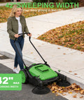 42 Inch Walk Behind Manual Floor Sweeper With 15 Gallon Waste Container And Wide Side Brushes For Garage Warehouse Yard Cleanup Heavy Duty Human Powered Build So You Can Sweep Floors With Zero Sweat Daily, shown in use on leaves.