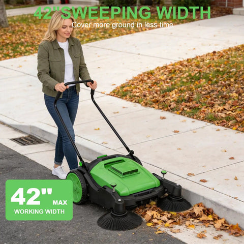 42 Inch Walk Behind Manual Floor Sweeper With 15 Gallon Waste Container And Wide Side Brushes For Garage Warehouse Yard Cleanup Heavy Duty Human Powered Build So You Can Sweep Floors With Zero Sweat Daily, shown in use on leaves.