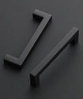 Close-up of 30 Pack Four And A Half Inch Square Kitchen Cabinet Handles Matte Black Pulls For Cupboards And Drawers Center To Center Spacing Four And A Half Inches Durable Metal Hardware, showing two handles on dark background.