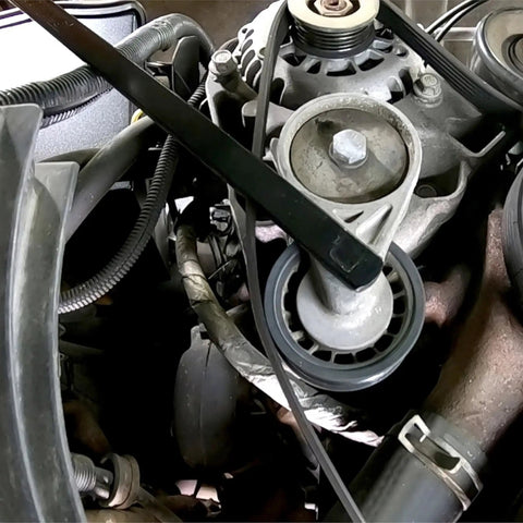 Pro Grade Serpentine Belt Tool Set With 3/8 Drive Handle in use for tensioner release in engine bay close-up