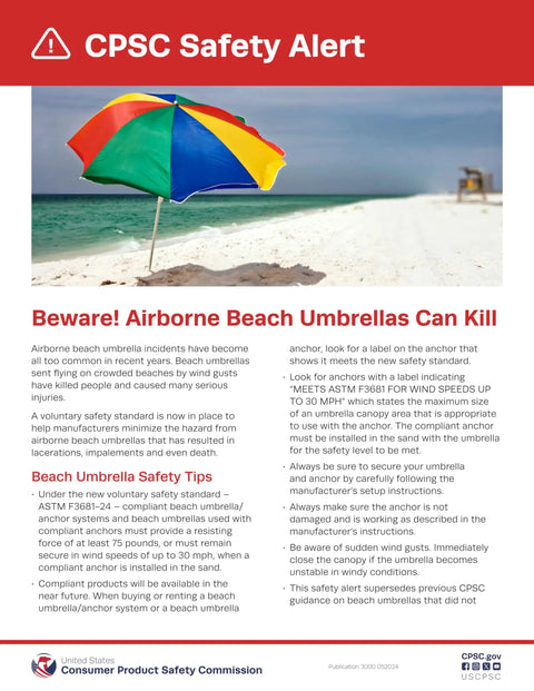 Colorful beach umbrella on sandy beach with safety alert text.