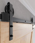 Heavy Duty Sliding Barn Door Hardware Kit With Reinforced Steel Rollers And Silent Tracks, close-up of matte black rollers and track.