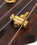Close-up of Top Tier Brass Guitar Roller String Retainers Fit Electric Guitars Perfectly, showing smooth string path on headstock.
