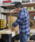 Person measuring wood on Heavy Duty Workbench Kit With ShelfLinks For Garage Shop Or Shed Organization Build A Custom Workspace