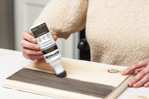 Person using No Mess Wood Stain And Applicator Kit, 4 Oz Dark Walnut, Water Based on wood piece, highlighting clean application.