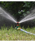 360 Degree Rotating Killer Sprinkler Set For Lawn And Garden Irrigation spraying water on grass with half inch nozzle