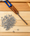 Stainless Steel Spring Washer Kit 200 Pcs For Screws And Bolts Pro Grade shown with pliers on wooden surface